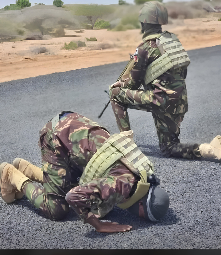 KDF Soldiers Bows in Prayer as a Fellow Officer Keeps Guard KDF Soldiers Bows in Prayer as a Fellow Officer Keeps Guard